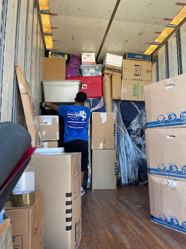 Professional movers carrying furniture during a local move in Denver, CO